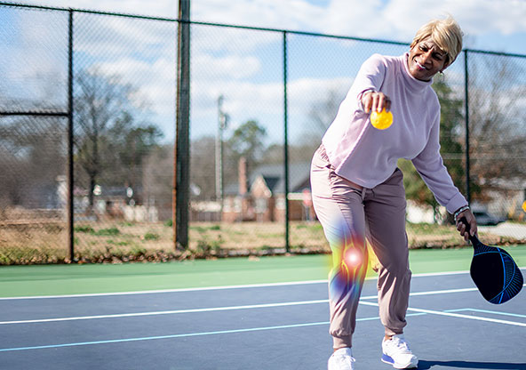woman playing pickleball after Knee Replacement